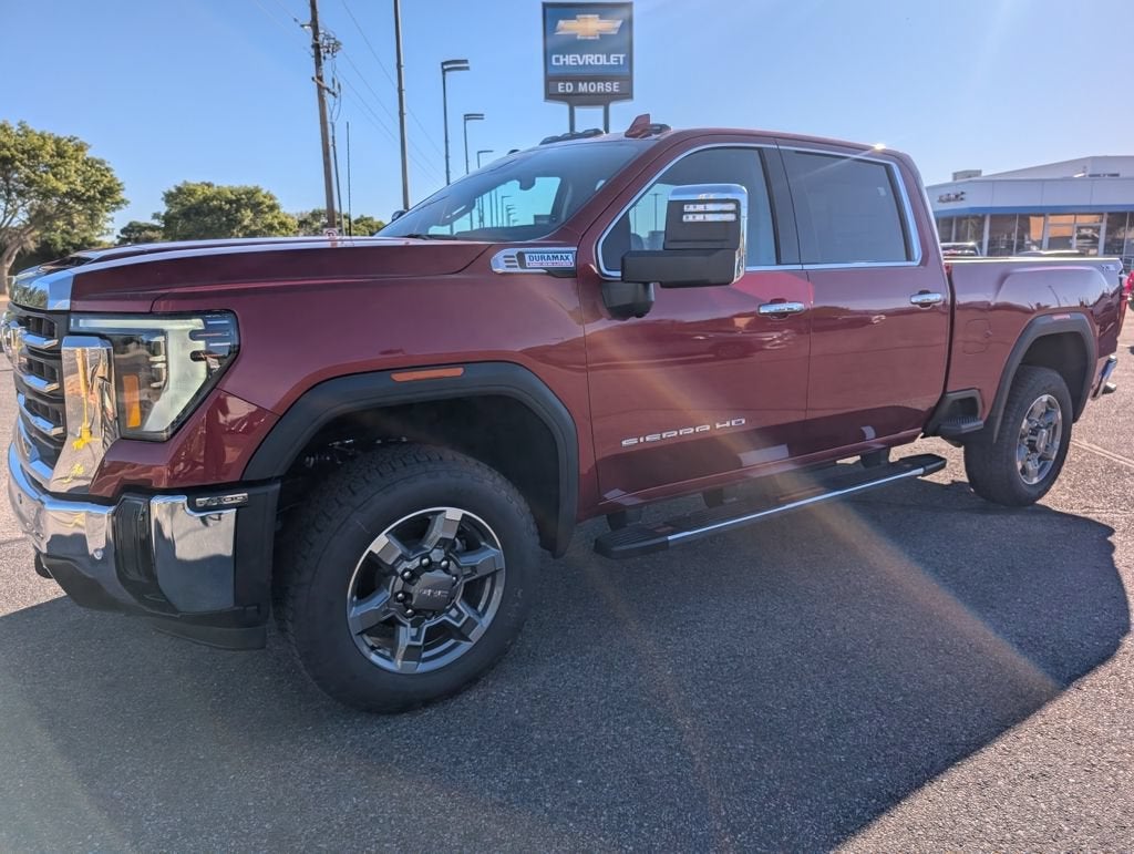 2026 GMC Sierra 2500 HD SLT in Volcanic Red Tintcoat — front three-quarter view
